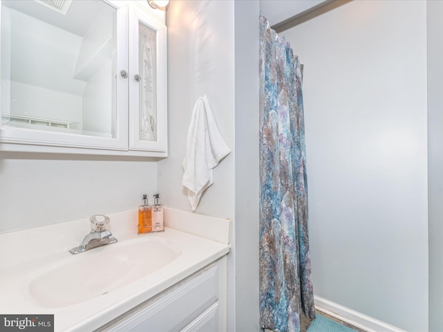 bathroom featuring vanity and baseboards