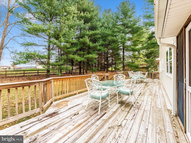 wooden terrace with outdoor dining space