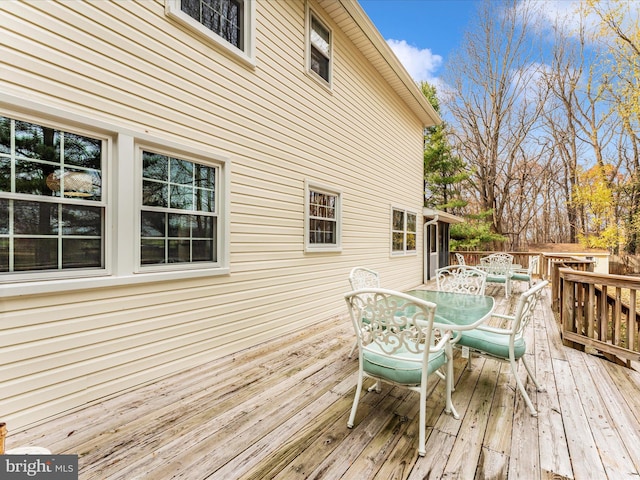 wooden terrace with outdoor dining area