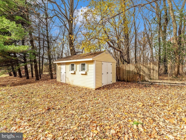 view of shed featuring fence