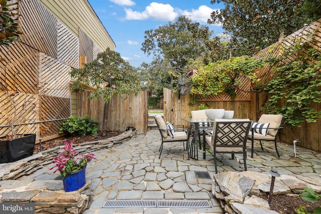 view of patio with outdoor dining area, outdoor lounge area, and fence