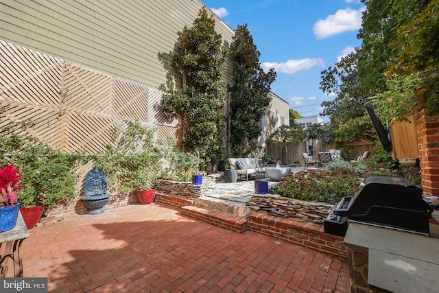 view of patio with grilling area and fence