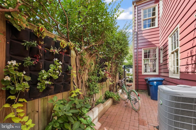 view of patio with fence and central AC unit