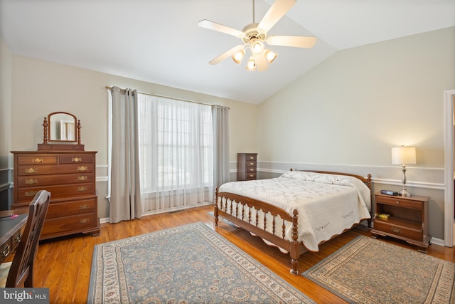 bedroom with lofted ceiling, ceiling fan, and light wood finished floors