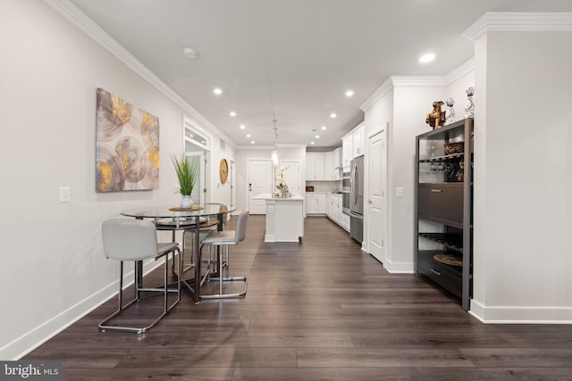 dining room with baseboards, ornamental molding, dark wood finished floors, and recessed lighting