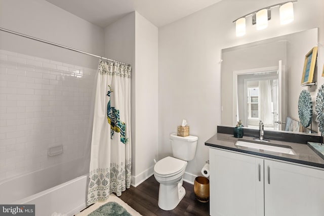 bathroom featuring shower / bath combo, baseboards, toilet, wood finished floors, and vanity