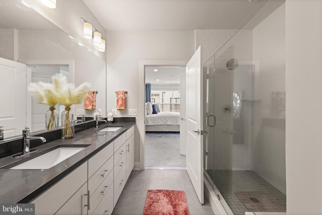 ensuite bathroom featuring ensuite bath, a shower stall, a sink, and tile patterned floors