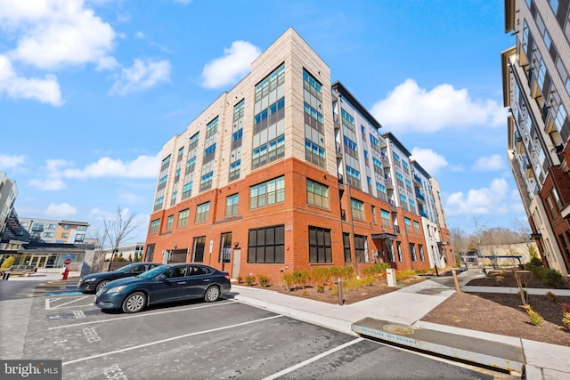 view of building exterior with uncovered parking