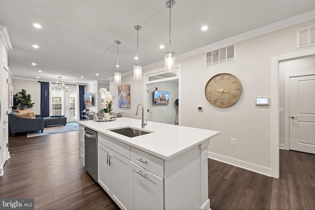 kitchen featuring light countertops, open floor plan, a kitchen island with sink, a sink, and white cabinetry