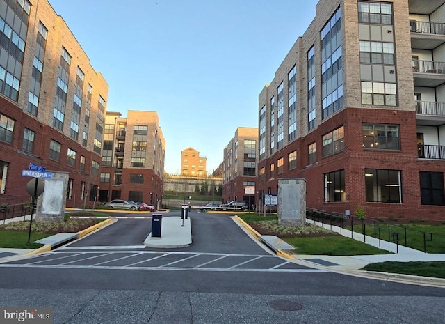 view of street featuring curbs, sidewalks, and a city view