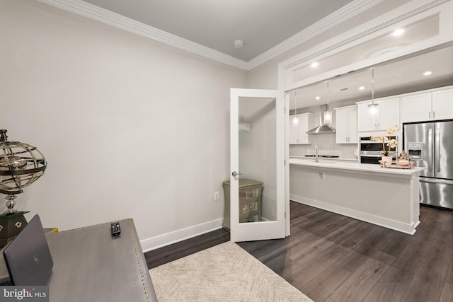 kitchen featuring a breakfast bar area, decorative light fixtures, stainless steel appliances, light countertops, and white cabinetry