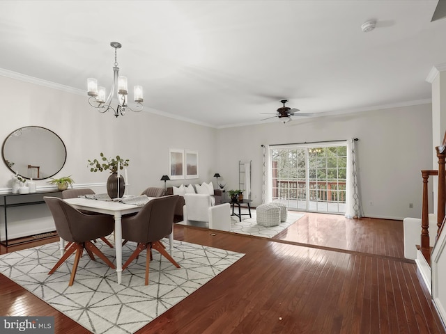 dining area featuring wood-type flooring, crown molding, and ceiling fan with notable chandelier