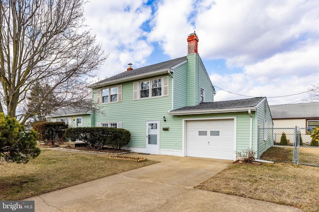 view of side of property featuring a garage, concrete driveway, fence, and a chimney