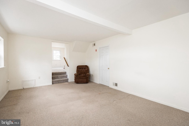 spare room featuring beam ceiling, visible vents, carpet flooring, baseboards, and stairs