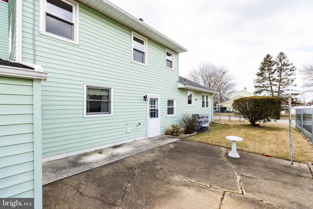 back of house featuring a yard, a patio area, and fence