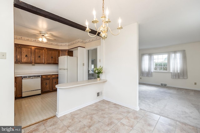 kitchen featuring light countertops, white appliances, visible vents, and light colored carpet