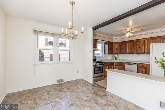 kitchen featuring light countertops, visible vents, freestanding refrigerator, stainless steel gas stove, and dishwasher