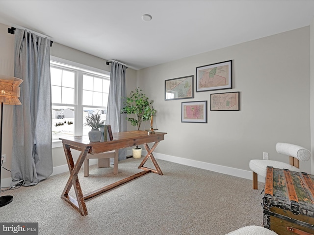 carpeted home office featuring baseboards