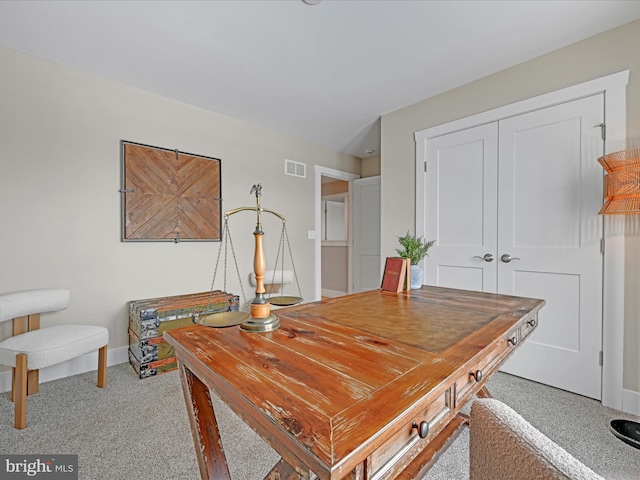 home office with carpet, visible vents, and baseboards