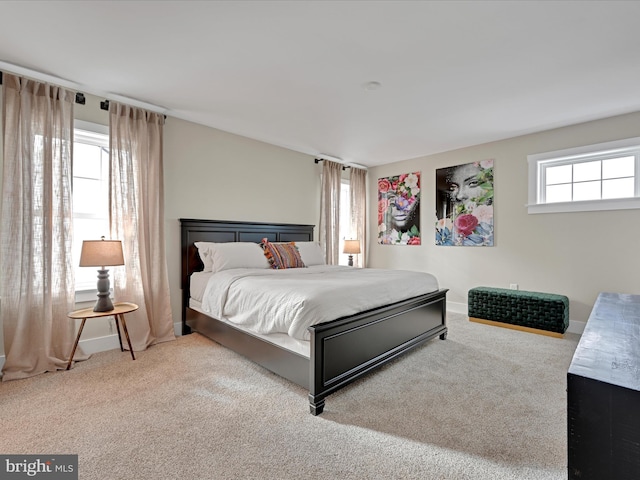 bedroom featuring carpet flooring and baseboards