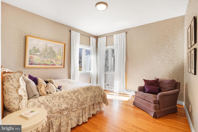 bedroom featuring light wood-style floors and baseboards