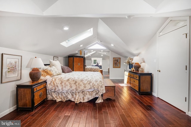 bedroom with lofted ceiling with skylight and wood finished floors