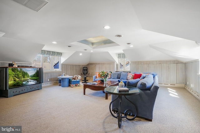 carpeted living area with a baseboard heating unit, lofted ceiling, and visible vents