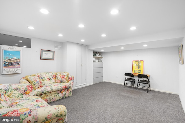 carpeted living area with visible vents, baseboards, and recessed lighting