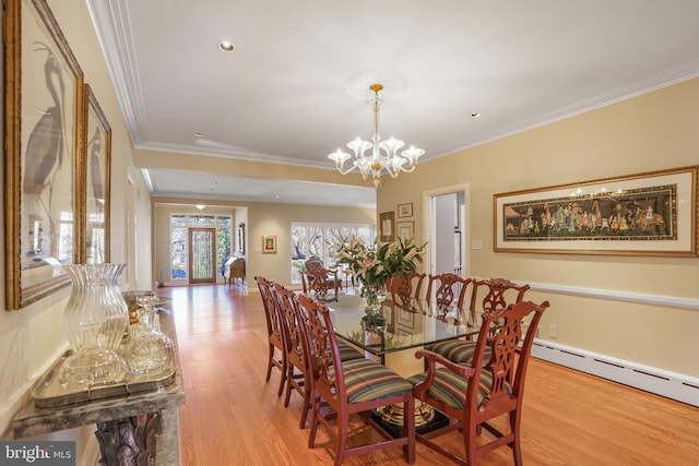 dining space with baseboards, ornamental molding, wood finished floors, baseboard heating, and a chandelier