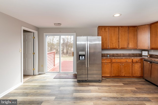 117 Quaker Neck Rd, Salem, NJ 08079 - kitchen featuring brown cabinetry, baseboards, light wood finished floors, appliances with stainless steel finishes, and dark countertops