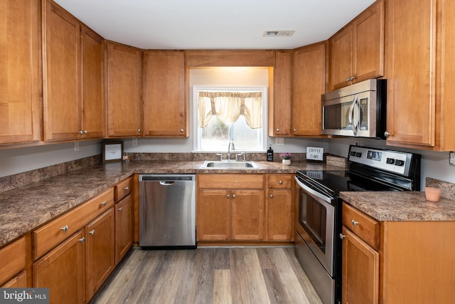 117 Quaker Neck Rd, Salem, NJ 08079 - kitchen with brown cabinetry, visible vents, appliances with stainless steel finishes, and a sink