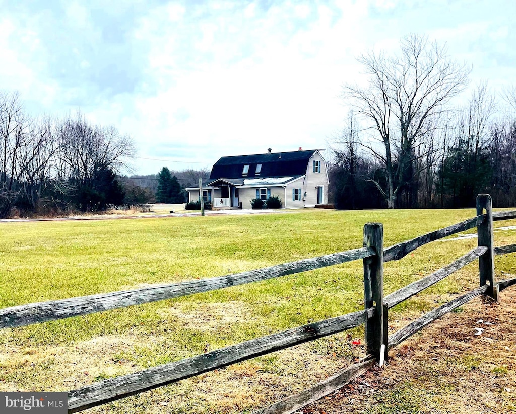 view of yard featuring a rural view and fence