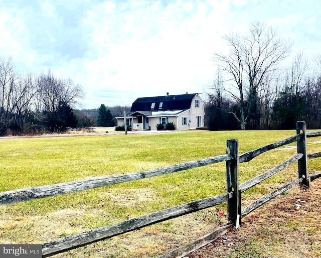 view of yard with a rural view and fence