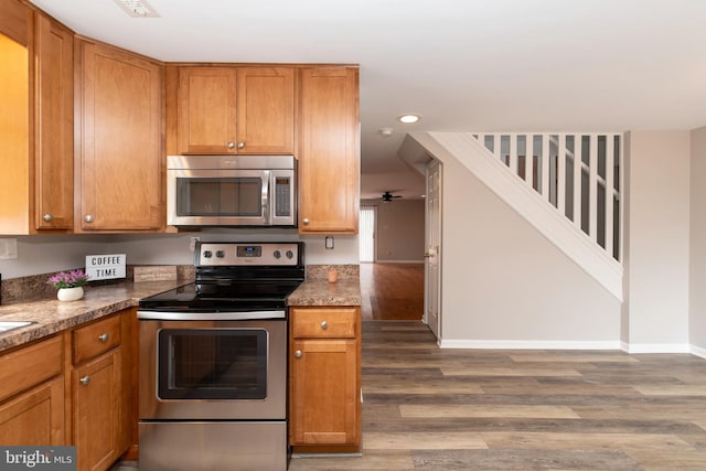 117 Quaker Neck Rd, Salem, NJ 08079 - kitchen featuring brown cabinetry, wood finished floors, baseboards, and appliances with stainless steel finishes