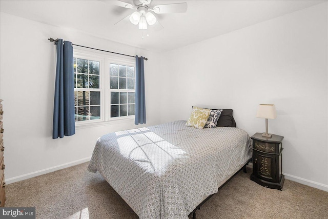 carpeted bedroom with ceiling fan and baseboards