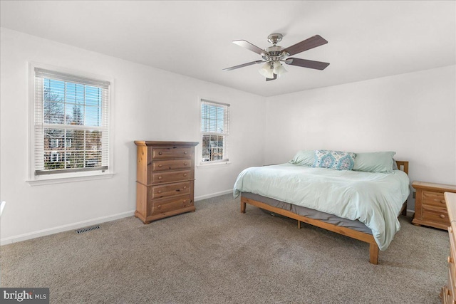 bedroom with a ceiling fan, carpet, visible vents, and baseboards