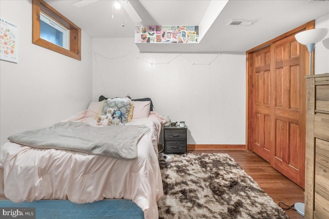 bedroom with baseboards, ceiling fan, and light wood finished floors