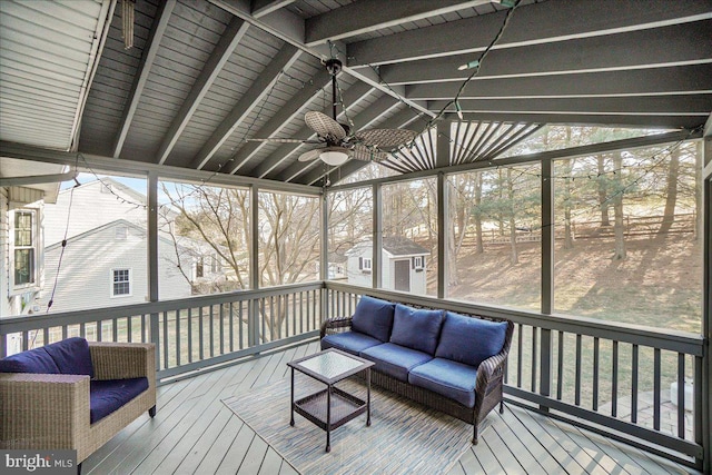 sunroom / solarium with a ceiling fan, a healthy amount of sunlight, and vaulted ceiling with beams