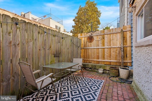 view of patio / terrace with outdoor dining space and a fenced backyard