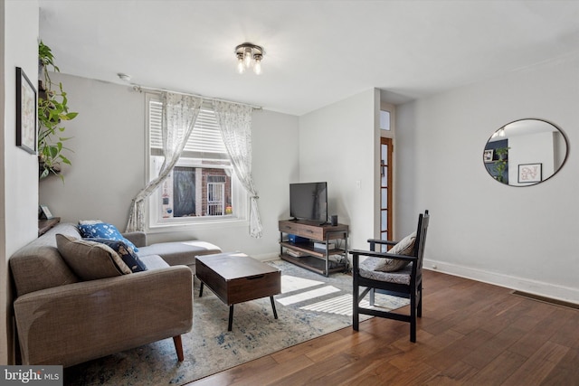 living room with baseboards and hardwood / wood-style floors