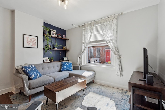 living room featuring baseboards and wood finished floors