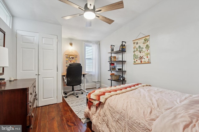 bedroom with dark wood-style floors, ceiling fan, and baseboards