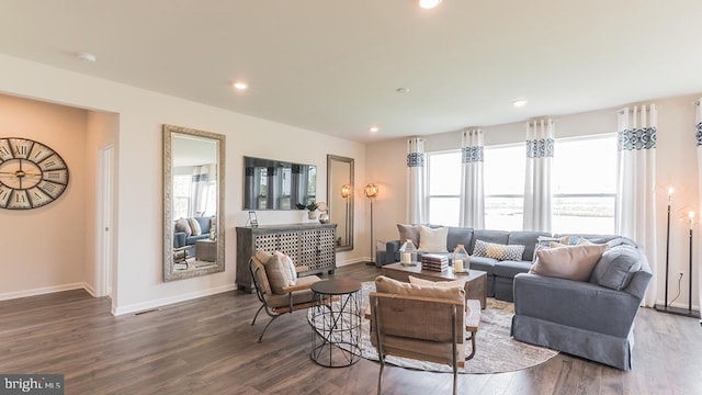 living area featuring baseboards, dark wood-style flooring, and recessed lighting