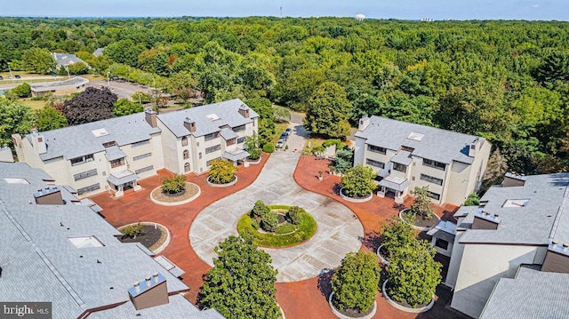 drone / aerial view with a residential view and a view of trees