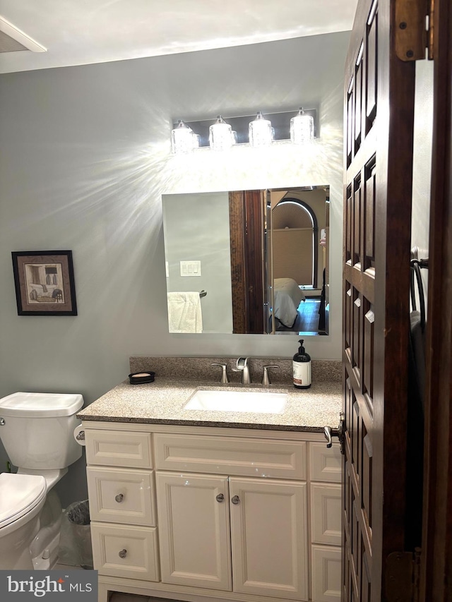 bathroom featuring vanity and toilet