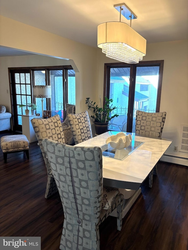 dining area with a baseboard radiator and wood finished floors