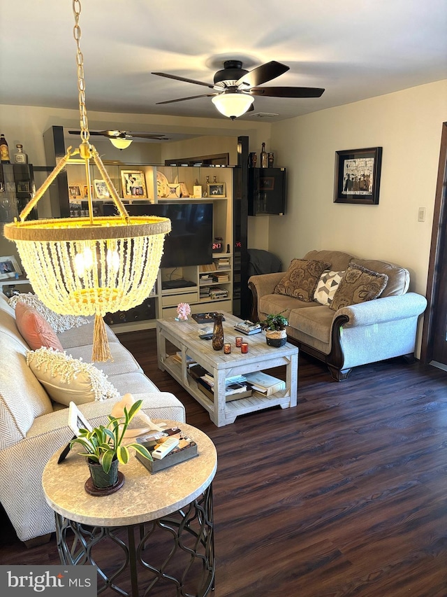 living area with a ceiling fan and wood finished floors