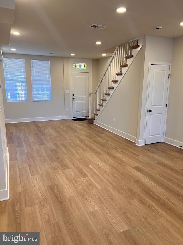 interior space with stairway, light wood-type flooring, visible vents, and recessed lighting