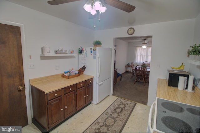 kitchen with light floors, open shelves, light countertops, light carpet, and white appliances