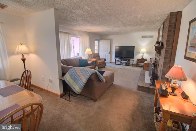 living area featuring baseboards, visible vents, a textured ceiling, carpet flooring, and a brick fireplace